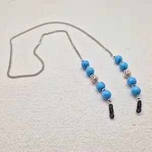 Chaine de lunettes femme maille fine palladium et perles turquoise et métal argenté ajouré, aux couleurs façon Reine des neiges