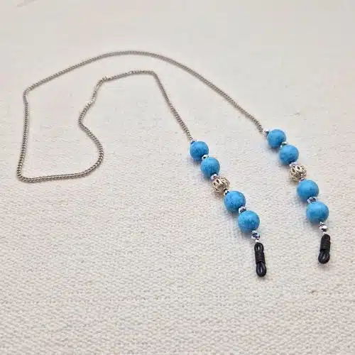 Chaine de lunettes femme maille fine palladium et perles turquoise et métal argenté ajouré, aux couleurs façon Reine des neiges