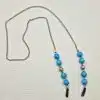 Chaine de lunettes femme maille fine palladium et perles turquoise et métal argenté ajouré, aux couleurs façon Reine des neiges